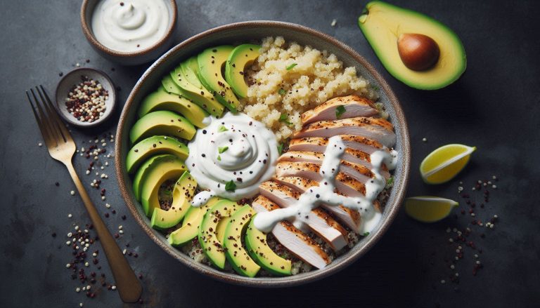 Assemble the bowls by layering quinoa, chicken slices, and avocado. Drizzle with the creamy yogurt dressing.